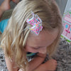 little girl wearing a unicorn glitter shaker no slip hair clip